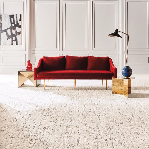 A red couch on a white carpet from Coverings by Design in Washington